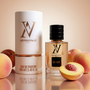 Aroma Vault Lush perfume bottle with packaging and peaches on a reflective surface
