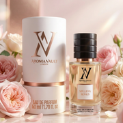Aroma Vault perfume bottle and packaging with pink roses in the background